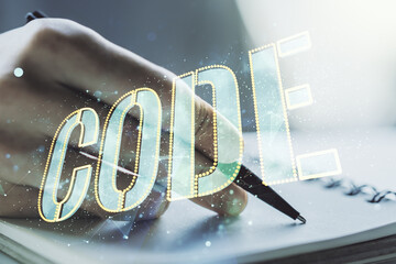 Poster - Creative Code word sign and man hand writing in notepad on background, international software development concept. Multiexposure