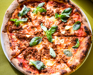 Wall Mural - tasty bolognese pizza with fresh basil