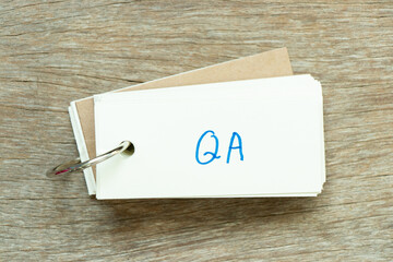 Poster - Flash card with handwriting word QA (abbreviation of quality assurance or question and answer) on wood background