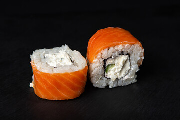 Canvas Print - Rolls on a black background. Traditional Japanese food.