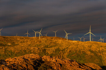 wind turbines illuminated by the midnight sun at Sommaroy (Sommarøy), Tromso Norway