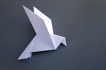Wall Mural - white paper dove origami isolated on a grey background