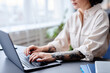 © Seventyfour - Cropped shot of tattooed young woman using laptop for work and typing on keyboard, copy space