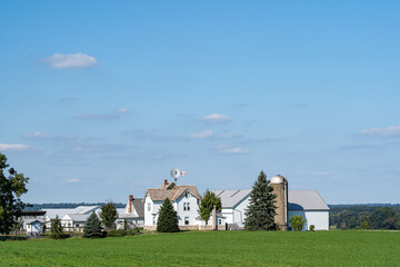 Poster - Amish farm on a green hilltop under a partly cloudy blue sky | Holmes County, Ohio