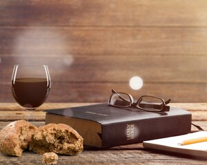 Chalice of wine with bread on light background. Holy concept