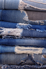 Wall Mural - Blue jeans denim heap background. Jeans fabric heap as material surface