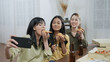 © S photographer - Holiday concept of 4k Resolution. Group of Asian female friends inviting online friends to eat pizza together at home. Fun and exciting leisure activities.