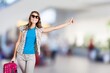 Happy young tourist woman holding baggage going to travel on holidays