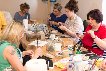 Wall Mural - Women in art workshop making decoupage boxes