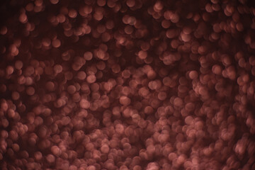 Wall Mural - Abstract background of multi-layered brown bokeh on a dark background. Lots of small brown glowing defocused circles. Can be used as a backdrop or overlay for your creatives as well as app backgrounds