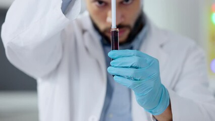 Aufkleber - Closeup of scientist or doctor hands working on research with blood sample in test tube using medical equipment in lab. Focused male biologist analyzing red liquid substance vial, wearing gloves.