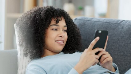 Poster - smiling, relaxing female typing on a phone, chatting on social media while lounging on a sofa at hom