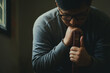 © Pcess609 - Man praying on the holy bible in the morning. Man hand with Bible praying, Hands folded in prayer on Holy Bible in church concept for faith, spirituality, religion.Christian life crisis prayer to god.
