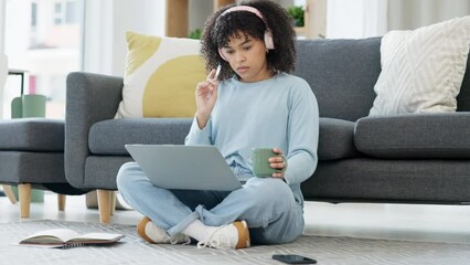 Aufkleber - Female university student thinking, working and studying on a laptop, preparing college exams and finals. Young woman listening to music, reading study material online and sitting on the floor