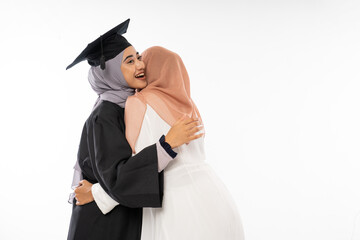 Wall Mural - Graduate female student wearing toga hugging her friend when to meet on isolated background