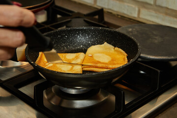 Poster - Chef pan-frying Crepe Suzette pancakes with cognac and citrus sauce