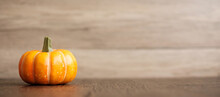 Orange Pumpkin On Table With Copy Space For Banner Background. Happy Halloween Day, Hello October, Fall Autumn Season, Festive, Party And Holiday Concept