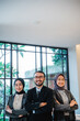 © Odua Images - businessman leader as he standing in front of his team smiling proudly to camera