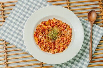 Wall Mural - Korean food Kimchi Fried Rice Kimchibokkeumbap, Rice fried with finely chopped kimchi. Beef, pork, onions, green onions, and other vegetables may be added according to taste.