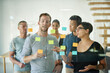 © Cecilie S W/peopleimages.com - Group of young designers planning on a glass board. A team having a brainstorming session for business ideas to meet company goals and objectives. Thinking business people in teamwork strategy.