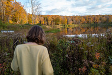 Millennial Woman Walking In Unspoiled Bohemian Landscape From Behind In Fall Foliage