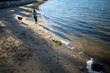 © Elijah Hurwitz - A woman plays with her dog on a rocky coastline beach