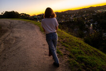 Woman In Jeans And White Shirt Walking In The Sunset On Canyon Trail In Mount Washington, Los Angeles