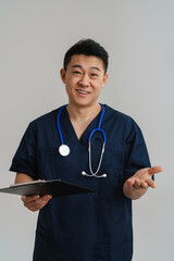 Wall Mural - Adult man wearing medical uniform and stethoscope holding clipboard