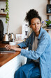 © Drobot Dean - Black young woman working with laptop while sitting in cafe