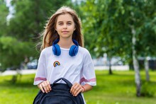 Girl In White T-shirt With Backpack Going To School