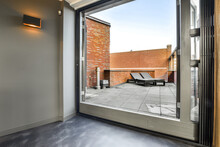 View Trough Glass Window Of Stylish Solarium Terrace Of A House