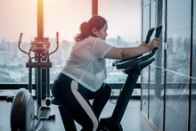 Fat Woman Trainer Under Setting Treadmill Program For Exercise Trainer Looking Happy Her Result During Workout. Fat Women Take Care Of Health, Want To Lose Weight Concept.