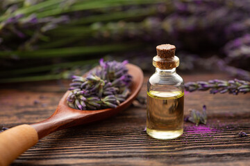 Wall Mural - Bottle with lavender oil and a fresh bouquet of flowers