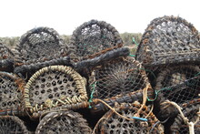 Ends Of Lobster Pots In A Pile Against A Stone Wall