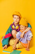 © Masson - Two kids in stylish vintage 80s clothes have a fun on yellow background