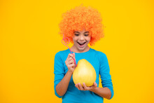 Funny Teenage Girl Hold Citrus Fruit Pummelo Or Pomelo, Big Green Grapefruit Isolated On Yellow Background. Happy Teenager Portrait. Smiling Girl.