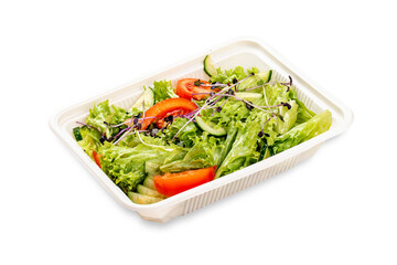 Wall Mural - Salad with fresh vegetables and microgreens. In a plastic container. Food to go. On a light background.