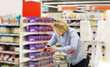 © lado2016 - Young man shopping in supermarket, reading product information