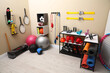© New Africa - Many different sports equipment in room with beige walls