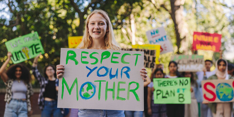 Wall Mural - Happy youth activist leading a march against climate change