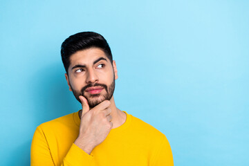 Wall Mural - Photo of dreamy thoughtful man wear yellow sweater looking empty space arm chin isolated blue color background