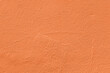 Saturated pastel orange colored low contrast Concrete textured background. Empty colourful wall texture with copy space for text overlay and mockups. 2023, 2024 color trend