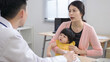© PRPicturesProduction - asian mother holding her baby is describing the medical problems to the pediatrician who’s sitting in front of her in the hospital office.