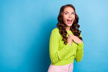 Canvas Print - Photo of nice woman wavy hairstyle palms touch chest unexpected luck wear trendy green knitwear jumper isolated on blue color background