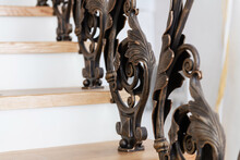 Wooden Stairs With Metal Wrought Iron Railings In A New House