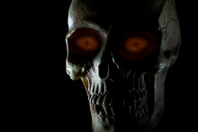Orange Eyes Glowing On A Human Skull