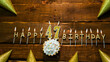 golden letters of the candle with the number happy birthday, the background of the pie with candles happy birthday on the background of brown stranded boards. Postcard Happy birthday 47
