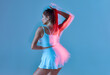 © Georgii - Rear back view of nice slim woman straight-haired having fun on blue background.