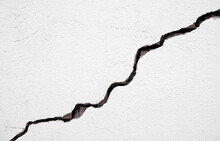 Long Deep Crack On The Damaged Wall As Texture Or Background