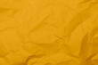Closeup yellow crumpled paper texture background. Yellow wrinkled paper texture background. Yellow crease fabric texture background. Yellow wrinkled fabric texture background.